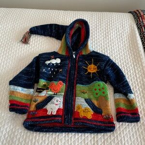 Adorable toddler alpaca sweater with tassled hood. Extremely soft wool.